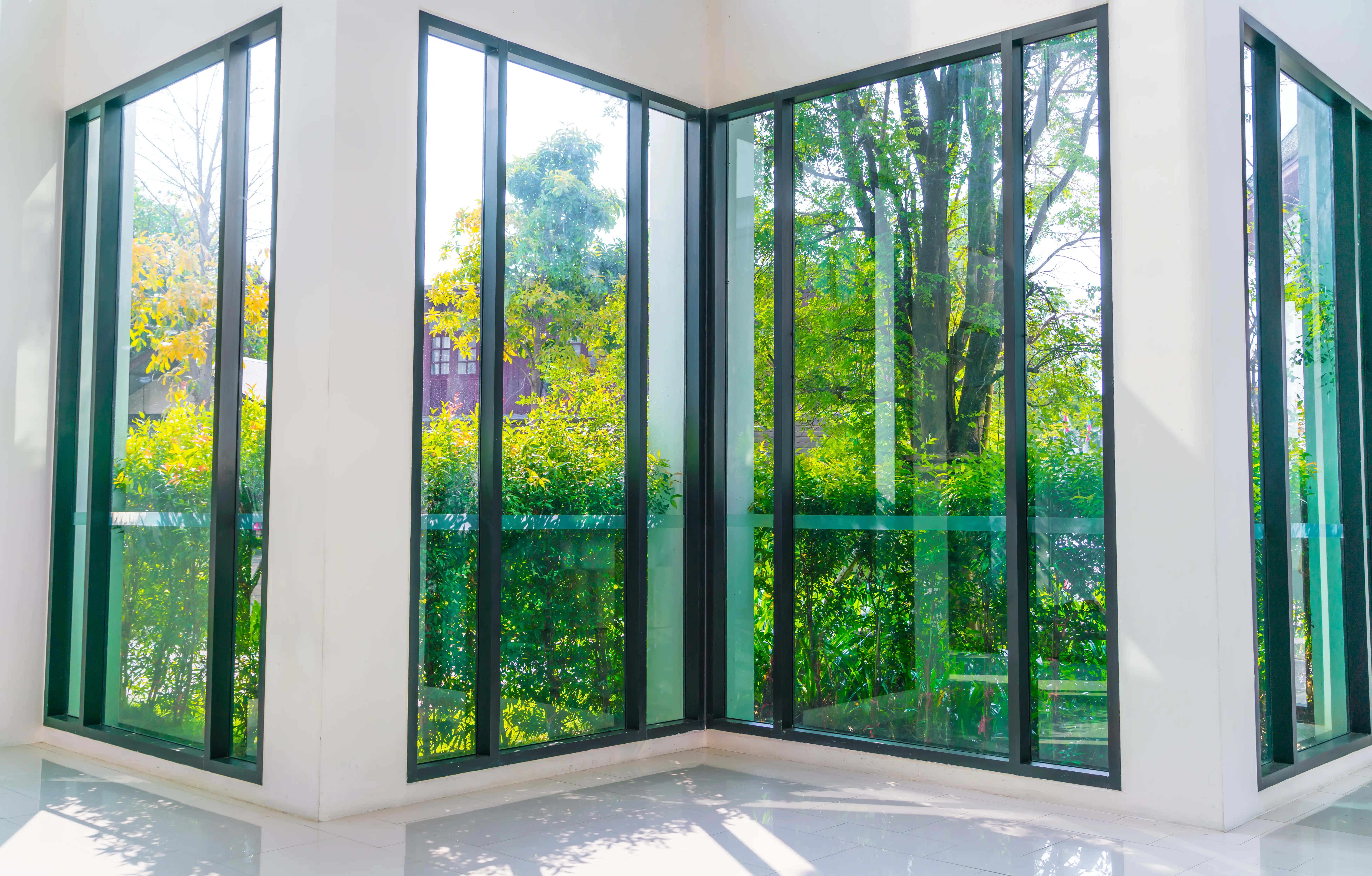 Habitación con ventanas de suelo a techo y vistas al jardín